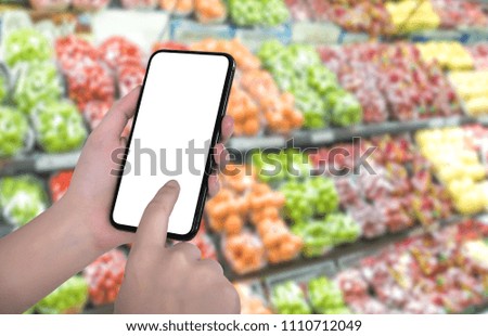 Using food app on a cell phone at the supermarket