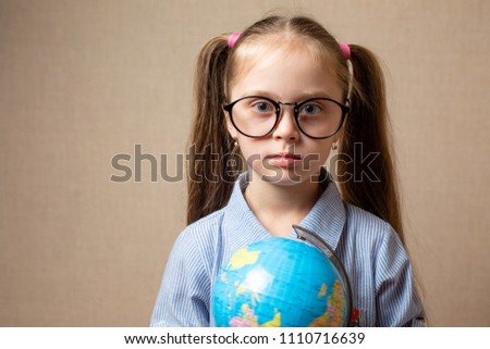 Cute little girl with globe.