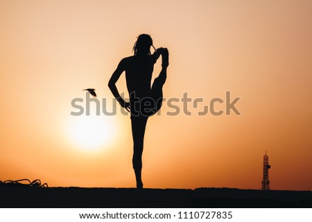 silhouette yoga at sunset