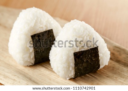 Onigiri, Japanese food, Japanese rice ball, rice triangle with seaweed  Royalty-Free Stock Photo #1110742901