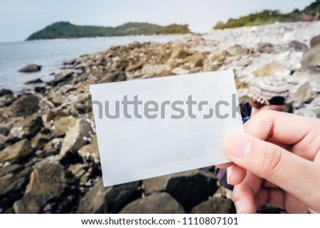 Girl Hand Holding Blank White Card On Beach In Summer, vintage filter