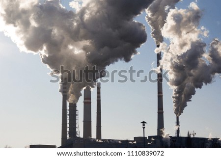Industrial power plant chimney with heavy steam