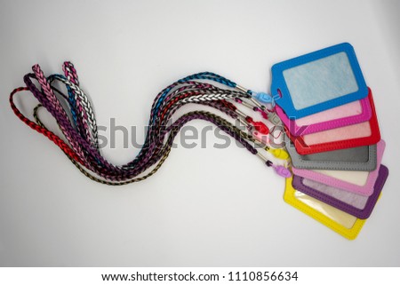 PU leather card holder with detachable weaving neck strap in different colors isolated on white background.