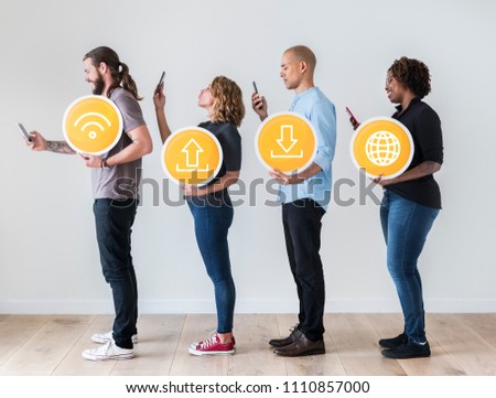 People using smartphones and holding technology signs