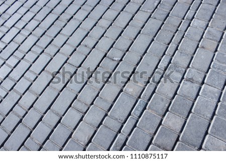 Abstract background of old cobblestone pavement close-up. 