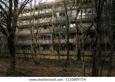 abandoned ruined house in Pripyat. empty apartment. broken windows, thickets of trees. abandoned building in Chernobyl, nuclear accident. Royalty-Free Stock Photo #1110889754