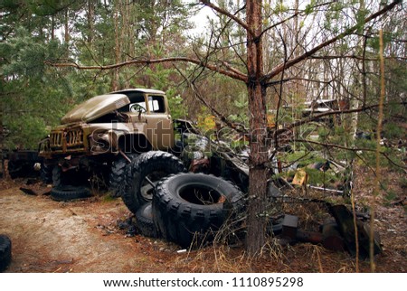dump of old cars in Chernobyl. radiation, forest, lost city Royalty-Free Stock Photo #1110895298