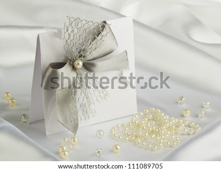 handmade wedding card on a white satin fabric