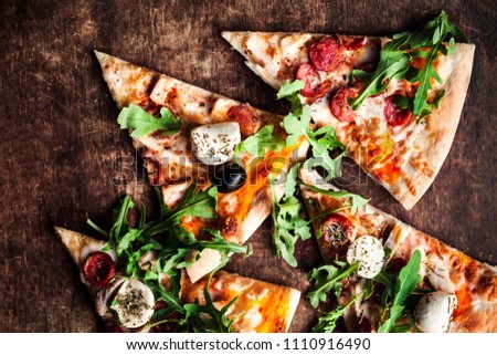 Hot pepperoni  pizza with salami and  cheese on rustic wooden table close up. Slice of hot pizza for lunch or dinner, top view with copyspace. Italian Fast Food
