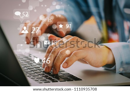 Social media and Marketing virtual icons screen concept.close up of businessman typing keyboard with laptop computer on wooden desk in modern office     Royalty-Free Stock Photo #1110935708
