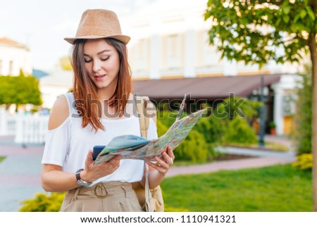 travel guide, tourism in Europe, woman tourist with map on the street