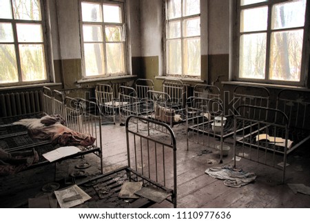Abandoned kindergarten in Chernobyl Exclusion Zone. Lost toys, A broken doll. Atmosphere of fear and loneliness. Ukraine, ghost town Pripyat. Royalty-Free Stock Photo #1110977636