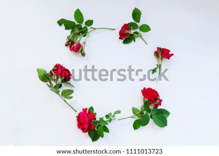 The homemade wreath of roses on a white background flat lay. With copy space