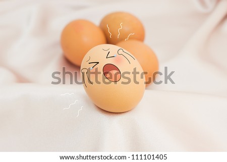 A single tear flowing down a brown egg