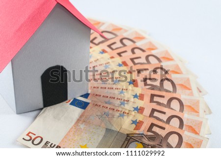 Mortgage and loan concept: paper house on a fifty euros banknote fan