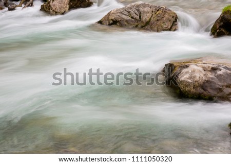 Waterfall in the Cares River located in the Picos de Europa National Park, Spain. Low shutter speed picture