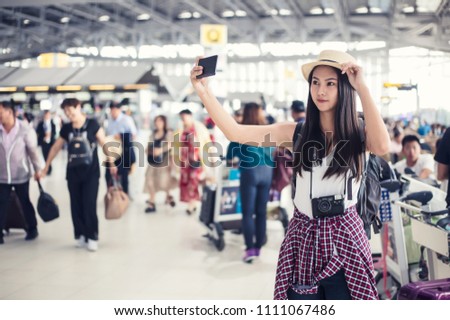 Young woman selfie in international airport, while waiting for her flight