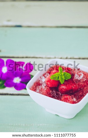 Sweet frozen strawberry in syrup with ice , dessert after main course