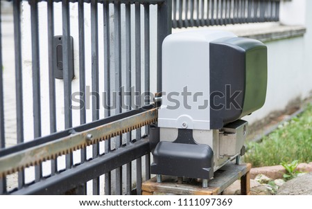 Engine opener for house entrance gate on remote control Royalty-Free Stock Photo #1111097369