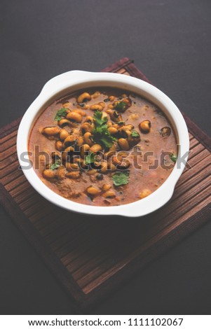 Black Eyed Kidney Beans Curry or Chawli chi usal / masala, served in a ceramic bowl over moody background, selective focus