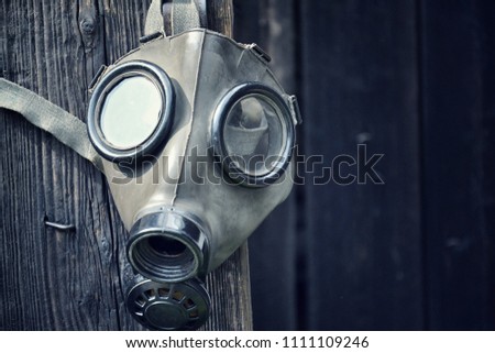 Old gas mask on wooden background, terrorism pollution apocalypse concept