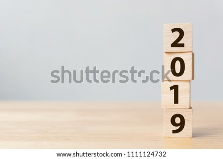 New year 2018 change to 2019 concept. Wooden block cube with number on table