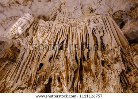 Closeup of stalactites and stalagmites in the cave.