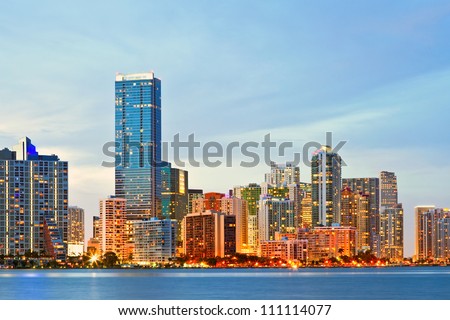 Miami Florida sunset over downtown illuminated business and luxury residential buildings and hotels. Cityscape of World famous travel location.