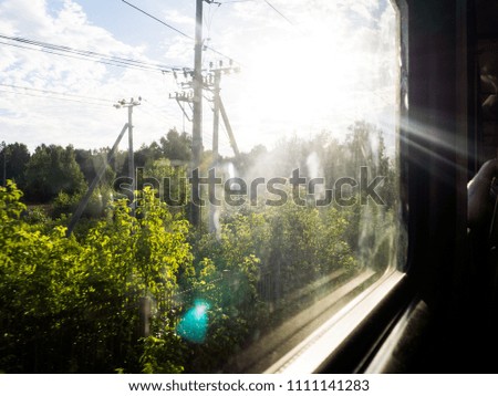view from the window of a train, partly blurred, on a Sunny day.
