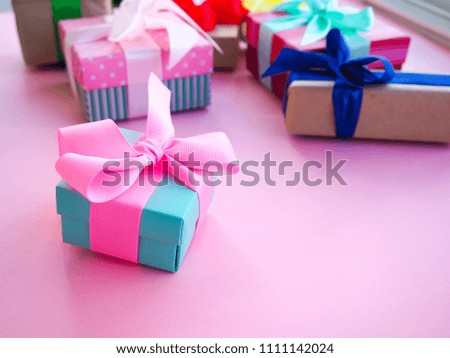 funny gift boxes on pink background, the concept of gift for the holiday.
