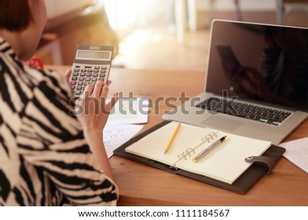 Asian business woman working in in coffee shop cafe with laptop paper work  (Business woman concept.)
