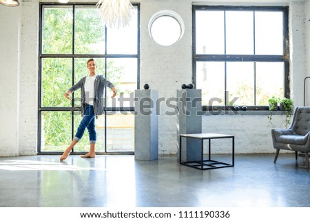 A handsome young male Ballet dancer practicing in a Loft style Apartment