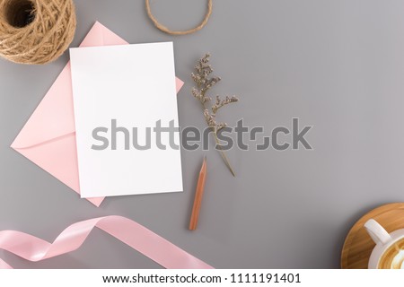 A wedding mock up concept. Wedding Invitation, envelopes, cards Papers on grey background with ribbon and decoration. Top view, flat lay, copy space