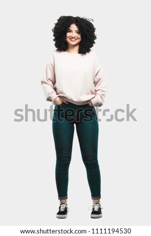 Full body young woman standing and  happy