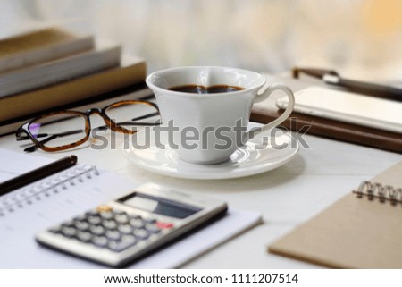 Workplace at home with morning coffee cup - Stock photo Coffee Cup, coffee - drink, books, calculator, glasses, notebook
