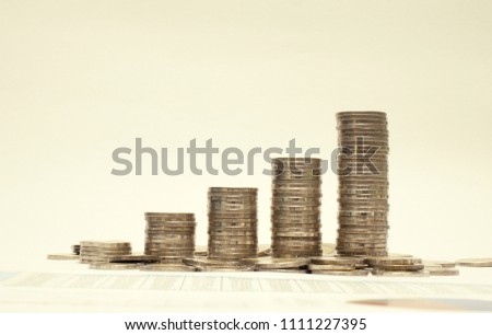 Graph from coins,Business growth concept,Financial growth,Increasing piles of coins on white background