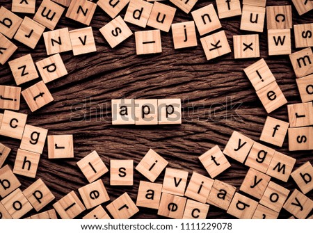 App word written cube on wooden background. Vintage concept.