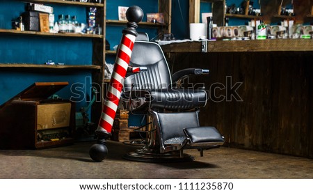 Barber shop pole. Logo of the barbershop, symbol. Stylish vintage barber chair. Hairstylist in barbershop interior. Barber shop chair. Barbershop armchair, hairdresser, hair salon, barber shop for men Royalty-Free Stock Photo #1111235870