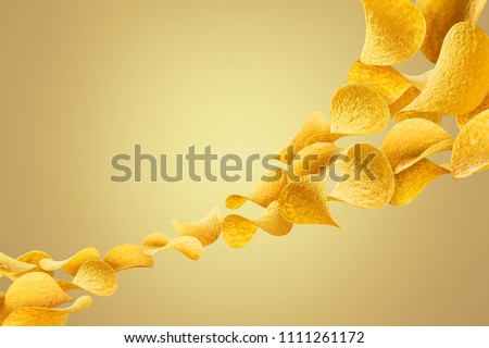 Flying potato chips, isolated on yellow gradient background Royalty-Free Stock Photo #1111261172