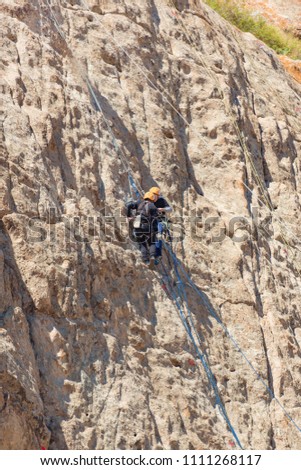 Mountain Climbing. Mountaineer in the mountains of Tamgaly Tas. Alpinism in Kazakhstan. Competitions in mountain tourism