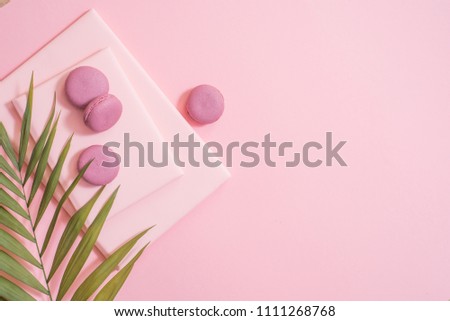 cake macaron, gift or present box and flower on pink table from above. Beautiful breakfast. Flat lay style.