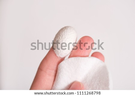 Set of Skin Care with silk cocoon on a white wood background. Beauty salon and spa concept. Royalty-Free Stock Photo #1111268798