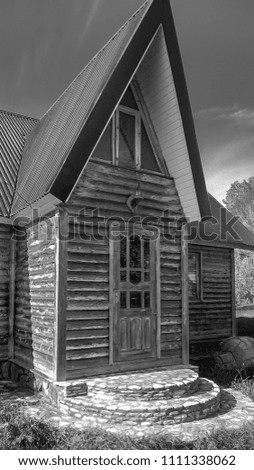 Black and white photo of an old wooden house