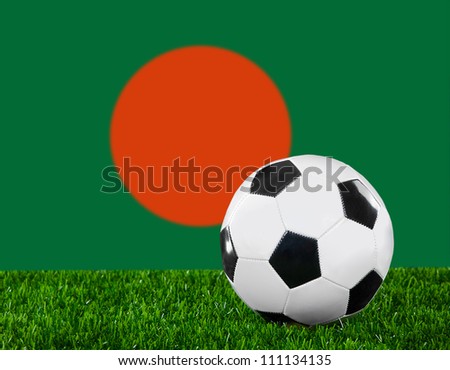 The Bangladesh flag and soccer ball on the green grass