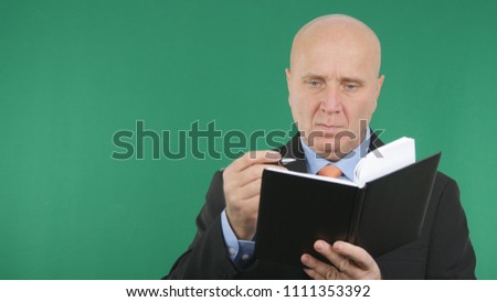 Businessman Image Working With Agenda and Green Screen in Background