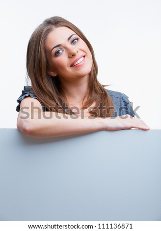 Smiling woman leaning on big blank board . Close up female face portrait with arms on blank card.