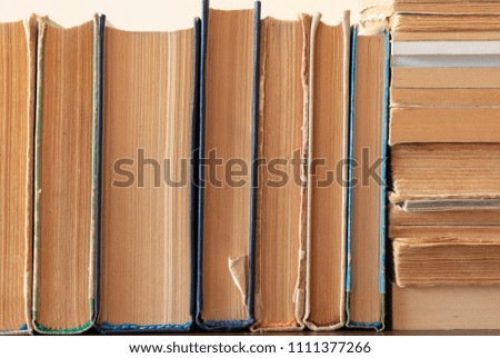 a lot of neatly stacked books on the shelf