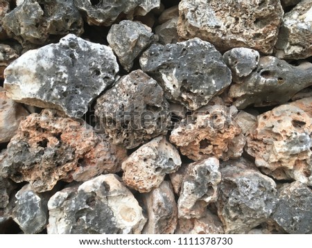 The retaining wall is made of natural stones. Horizontal photography.