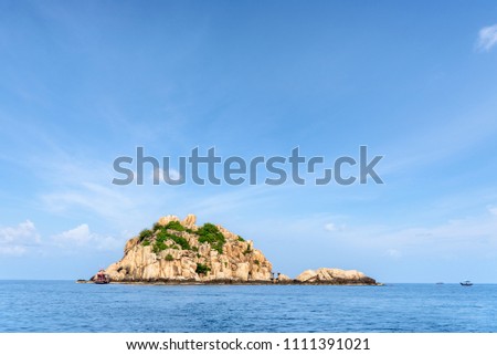 Beautiful nature landscape of Shark Island Divesite small rock island at Ko Tao under the blue sky on the sea in summer is a famous tourist attractions in the Gulf of Thailand, Surat Thani, Thailand
