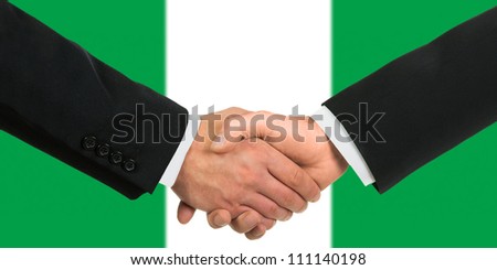 The Nigerian flag and business handshake